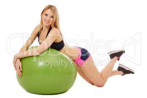 Sexy blonde laying on green fitness ball