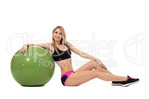 Smiling athletic woman posing with fitness ball