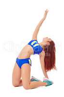 Graceful brunette doing pilates exercise