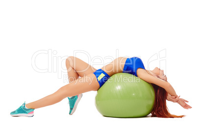 Relaxed athlete resting lying on fitness ball
