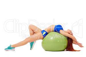 Relaxed athlete resting lying on fitness ball