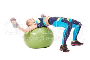 Girl exercising with dumbbells on fitness ball
