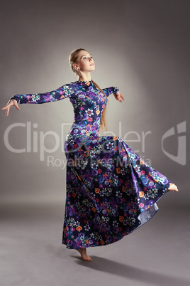 Graceful female dancer posing in stylish dress