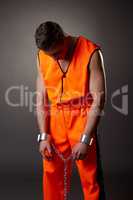 Studio shot of prisoner bowed his head