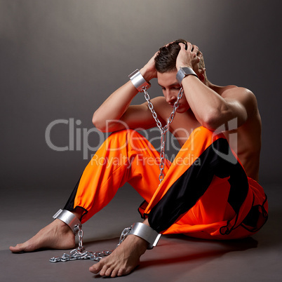 Hopeless man in handcuffs grabbed his head