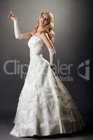 Lovely blonde posing in elegant wedding dress