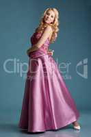 Beautiful young girl posing in long pink dress