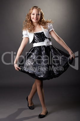 Smiling elegant girl making curtsy at camera