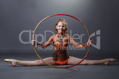 Happy flexible gymnast posing with hoop