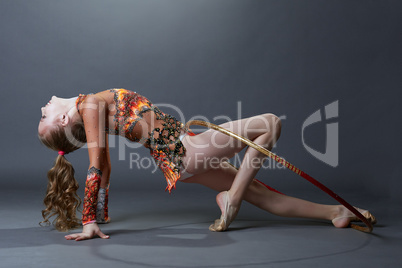 Side view of smiling gymnast performing with hoop