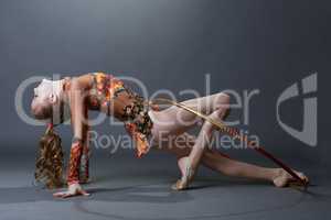 Side view of smiling gymnast performing with hoop