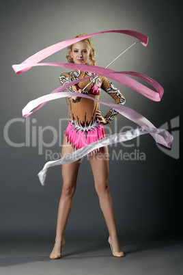 Rhythmic gymnastics. Cute girl dancing with ribbon