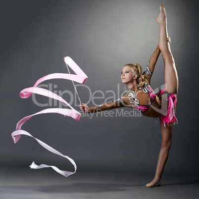 Rhythmic gymnast doing vertical split with ribbon