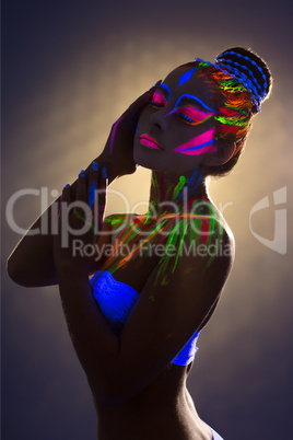 Sensual female dancer with luminous body art