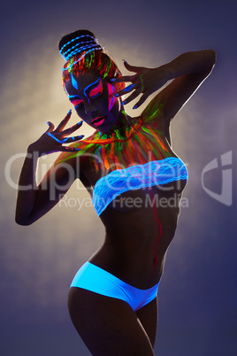 Seductive female dancer with luminous body art