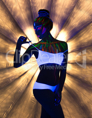 Seductive slender girl dancing in neon light