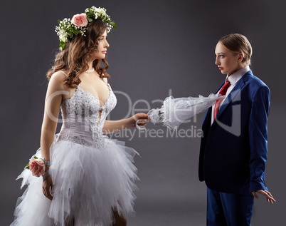 Gay marriage. Sexy bride pokes groom with umbrella