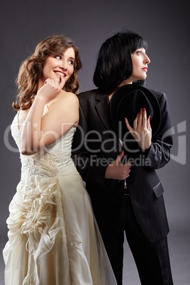 Elegant lesbian couple posing as bride and groom