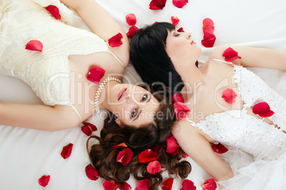 Top view of beautiful brides with rose petals