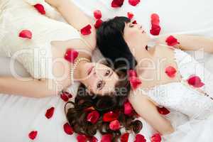 Top view of beautiful brides with rose petals