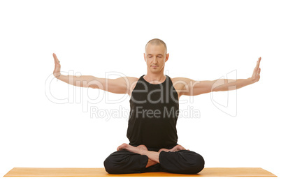 Image of concentrated man doing yoga exercise