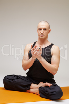 Yoga man posing at camera while exercising
