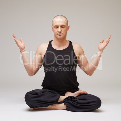 Studio photo of yoga instructor meditating