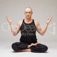 Studio photo of yoga instructor meditating