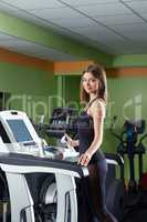 Image of lovely girl training on treadmill
