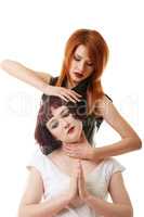 Sexy red-haired woman doing neck massage to girl