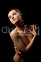 Passionate topless woman hugging herself shoulders