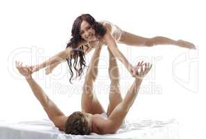 Cheerful prelude. Couple engaged acrobatics in bed