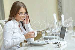 Business lunch. Charming woman working at dinner