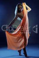 Nude girl dancing with cloth in ultraviolet light