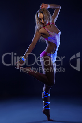 Go-go showgirl posing at camera in UV light