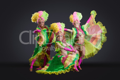 Sexy dancers posing in colorful carnival costumes