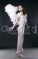 Innocent girl posing dressed in suit of angel