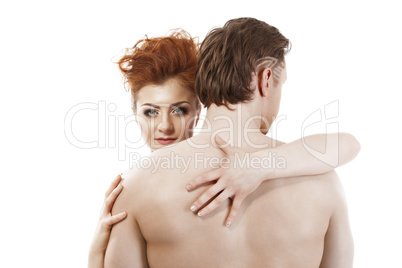 Confident red-haired beauty imperious hugging man