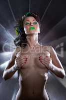 Naked disco dancer covering breasts with her hands