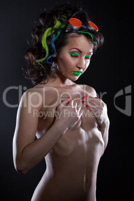 Nude go-go dancer with colorful neon make-up