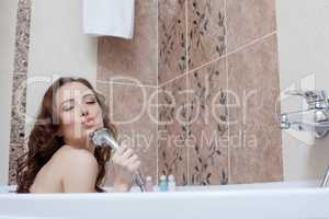 Woman fooling around while singing in bathroom