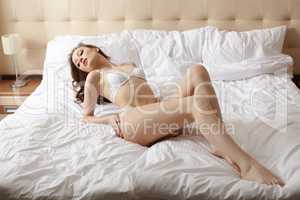 Image of pretty relaxing woman posing in bed