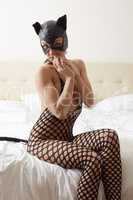 Model advertises catwoman costume in hotel room