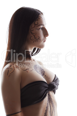 Side view of brunette with henna patterns on body