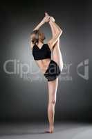 Back view of flexible girl doing vertical split