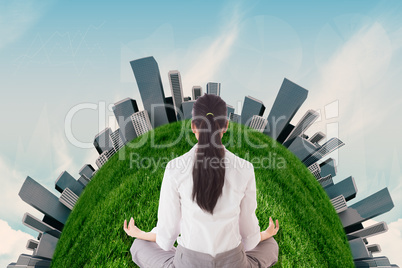 Composite image of businesswoman sitting in lotus pose