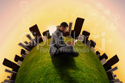 Composite image of businessman sitting and holding tablet