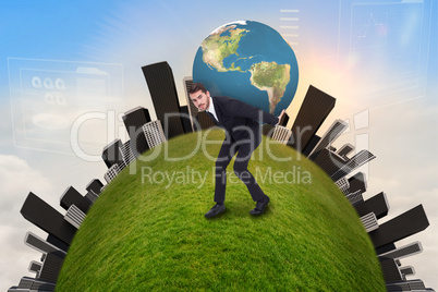 Composite image of businessman carrying the world