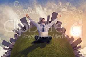 Composite image of businessman sitting on the floor cheering