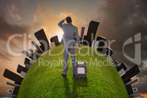 Young businessman standing with suitcase